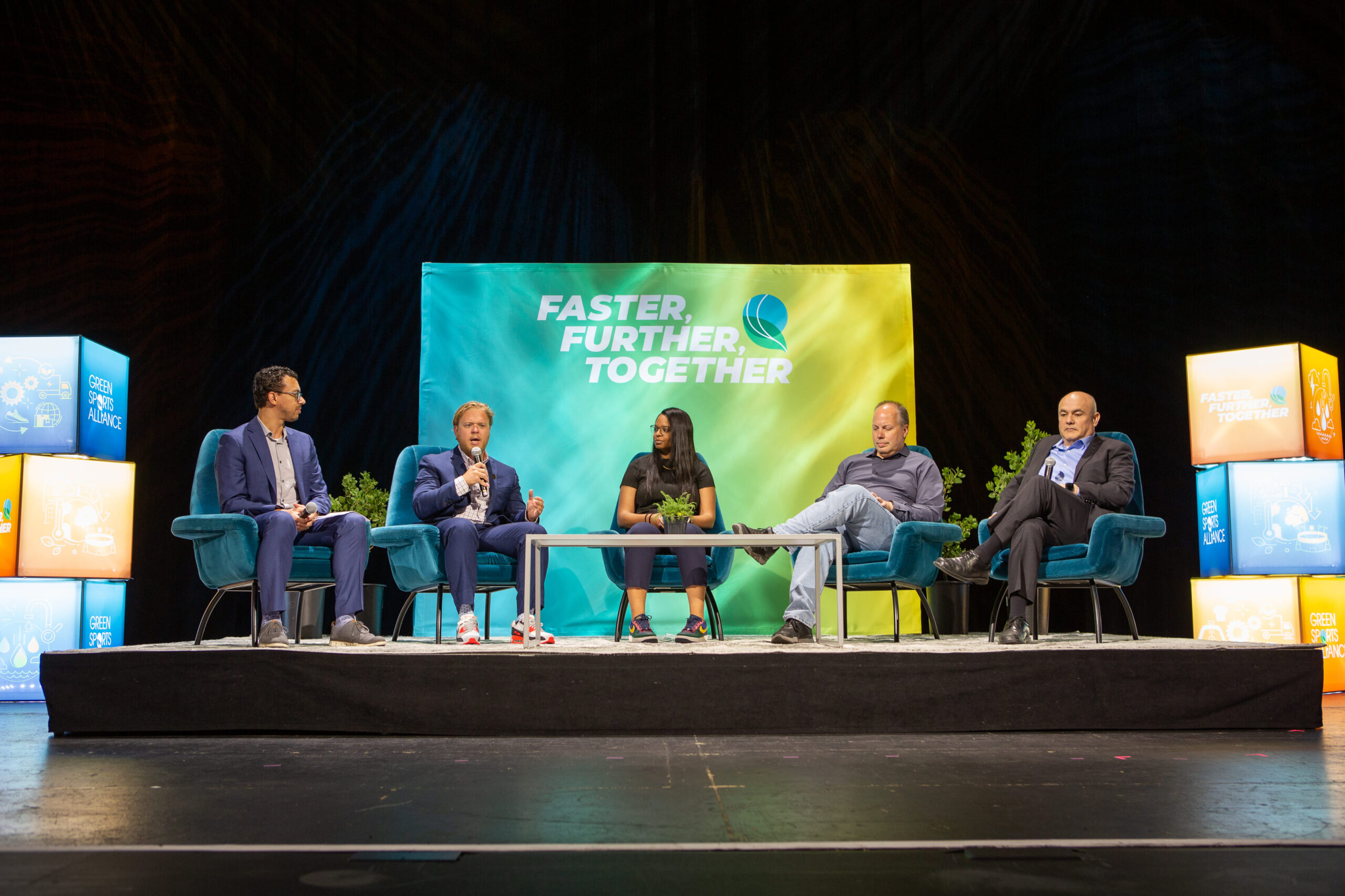 Panel discussion at the Green Sports Alliance Summit featuring sustainability leaders on stage.