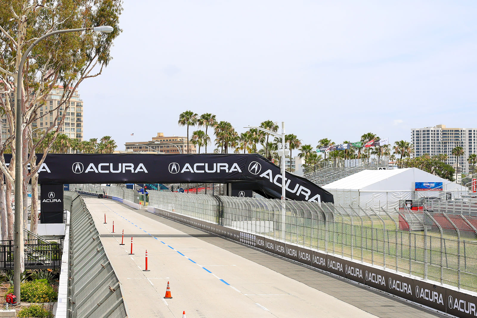 Custom Acura-branded trackside fencing and large-format event graphics installed along the Acura Grand Prix of Long Beach racecourse.