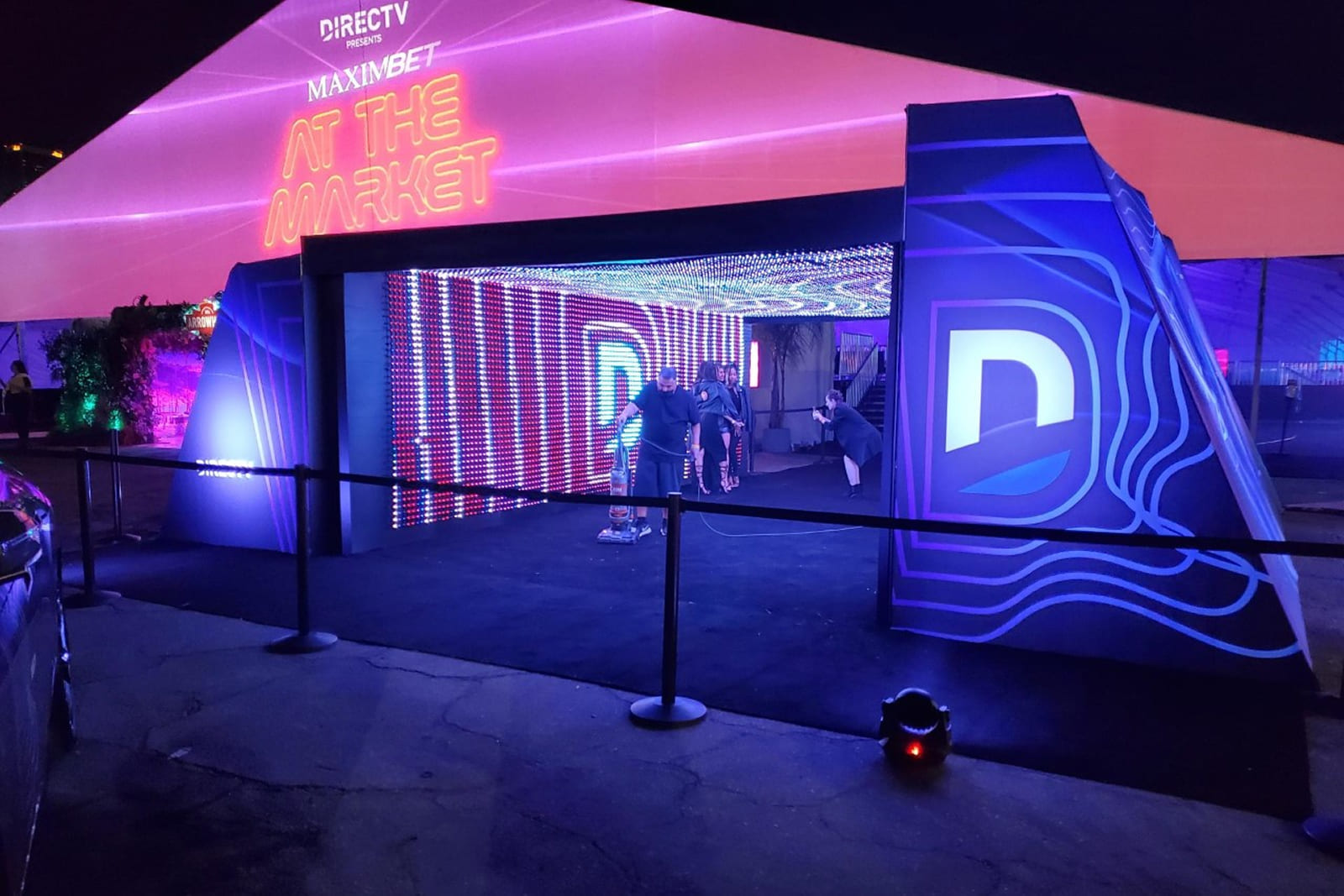 Front entrance to the DIRECTV immersive tunnel activation with custom graphics, LED displays, and branded environmental elements created by A3 Visual.