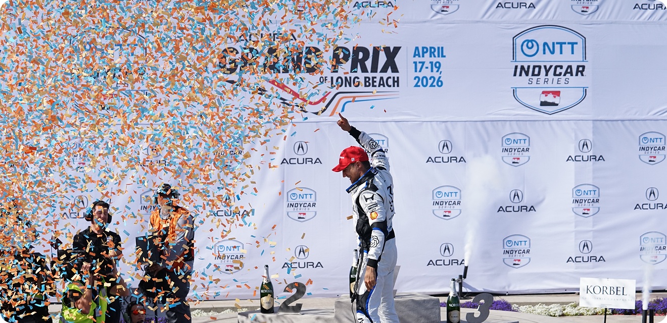 A3 Visual-produced podium backdrop and championship branding at the 2026 Acura Grand Prix of Long Beach as the race winner celebrates during the awards ceremony.