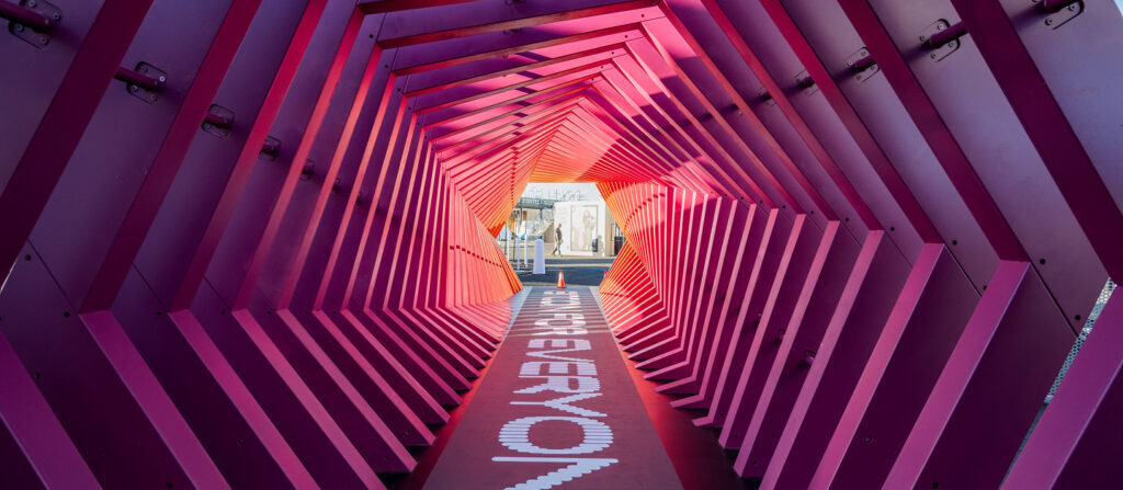 Immersive branded tunnel featuring custom graphics created for Block By Block 2025 at the Oakland Coliseum.