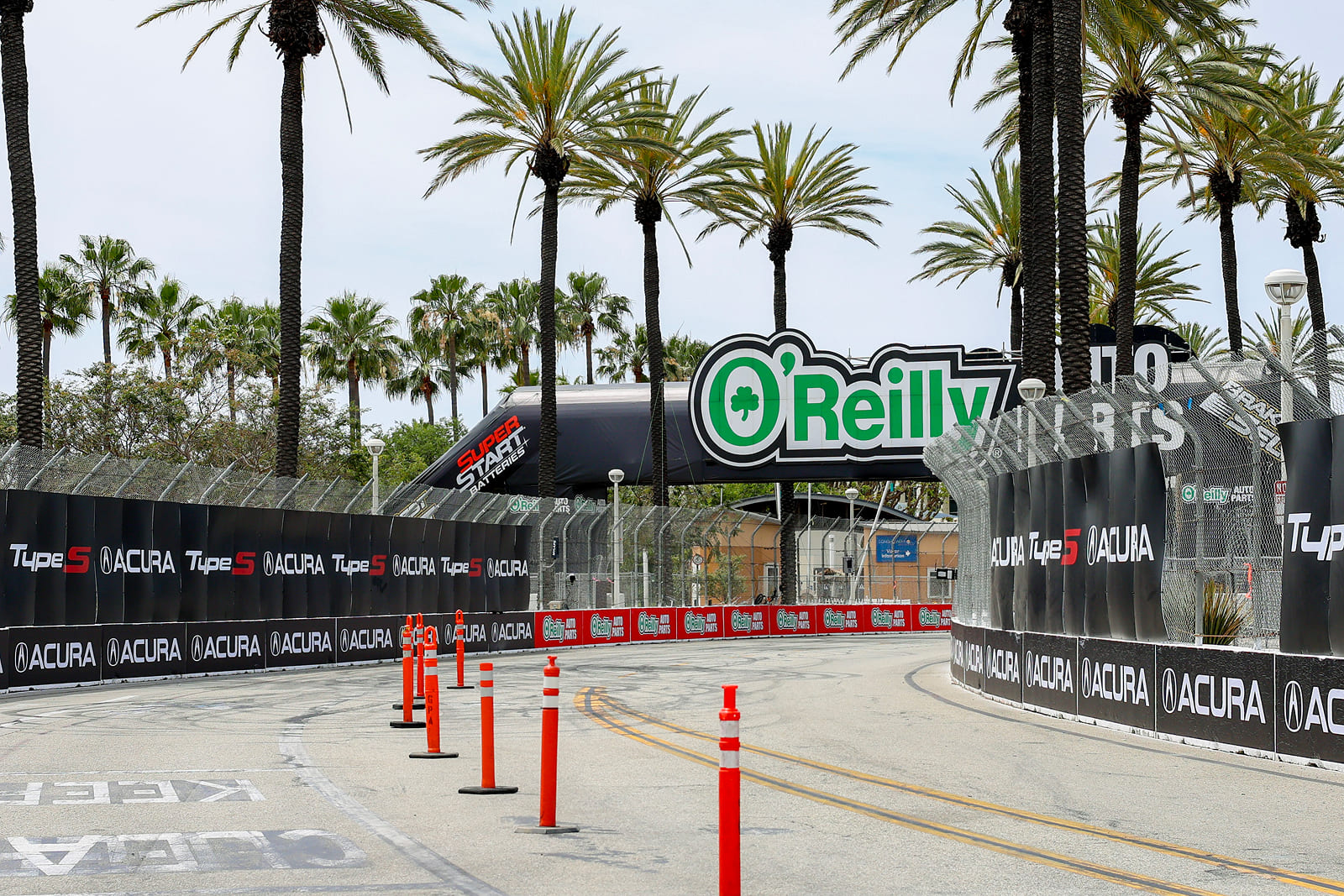 Large-format sponsor and event graphics installed along pedestrian walkways at the Acura Grand Prix of Long Beach.