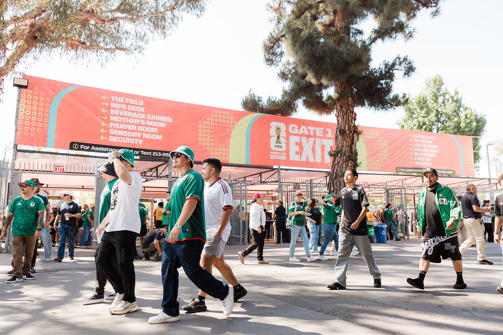 Fans arriving at FIFA Fan Fest surrounded by custom environmental graphics and wayfinding signage produced by A3 Visual.