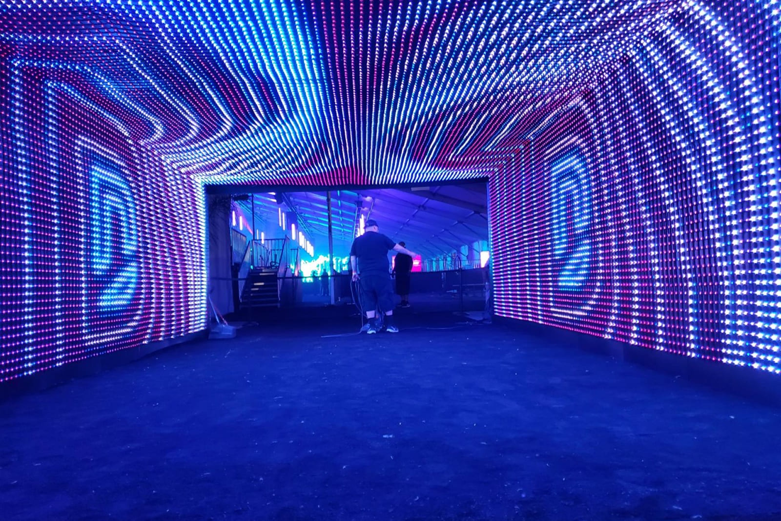 Interior view of the DIRECTV tunnel activation showcasing LED walls, custom graphics, and immersive branding produced by A3 Visual.