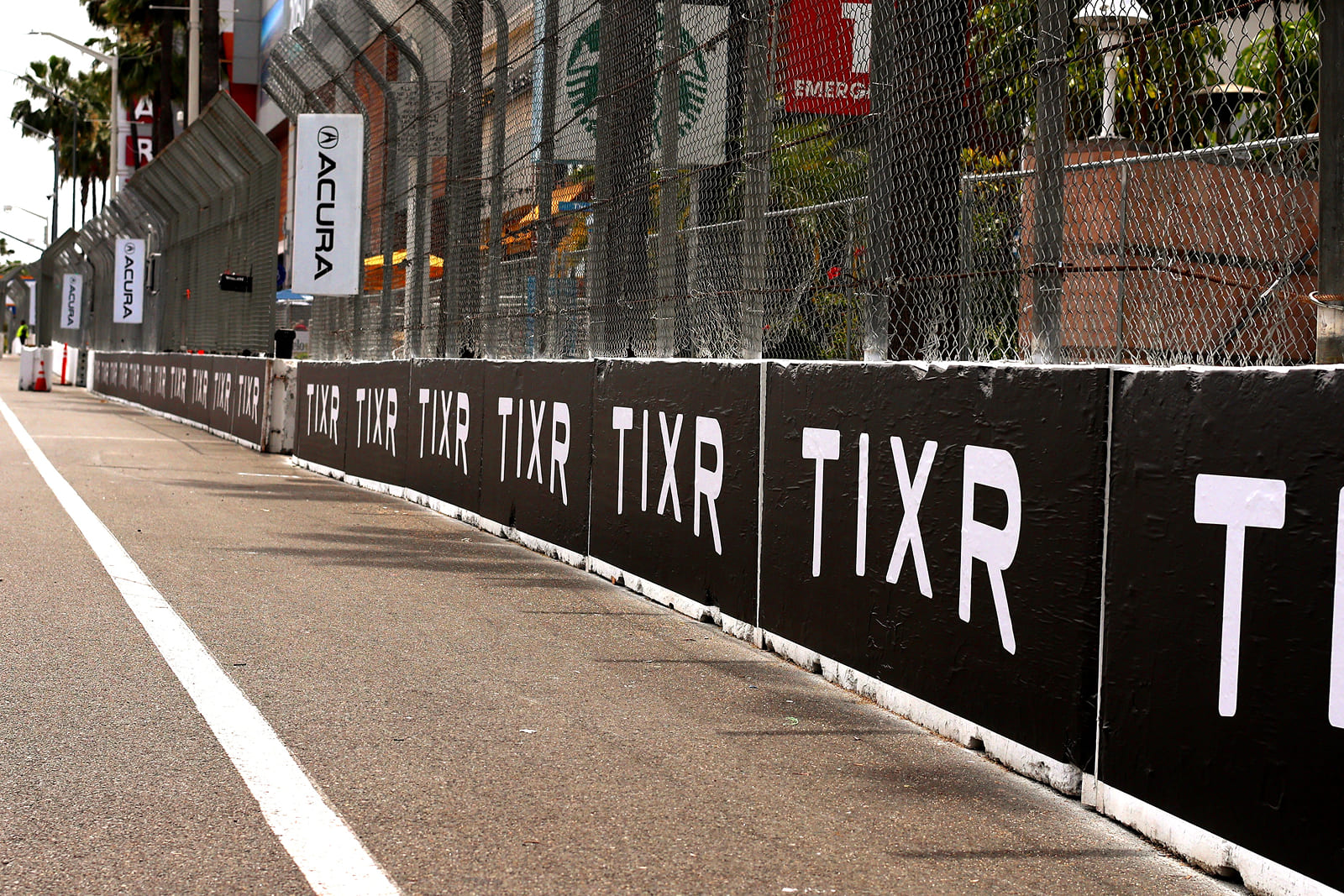 Large-format sponsor fencing and event branding installed throughout the Acura Grand Prix of Long Beach street circuit.