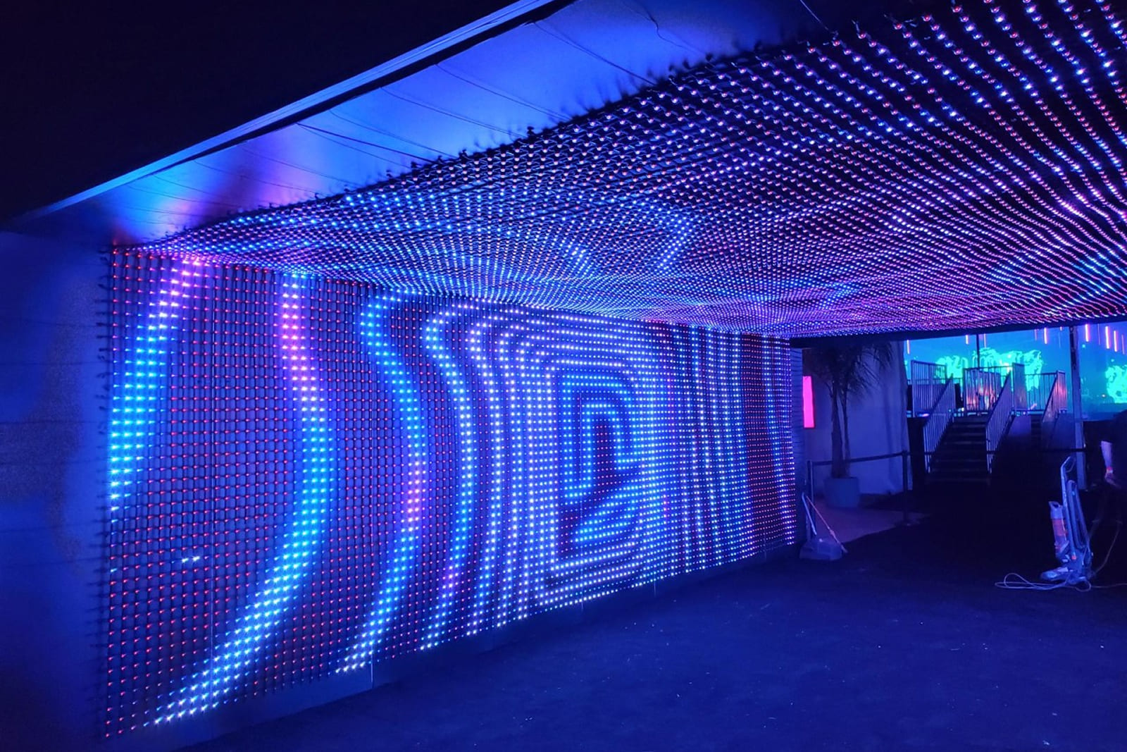 Side view of the immersive DIRECTV tunnel featuring custom large-format graphics and integrated LED displays installed by A3 Visual.
