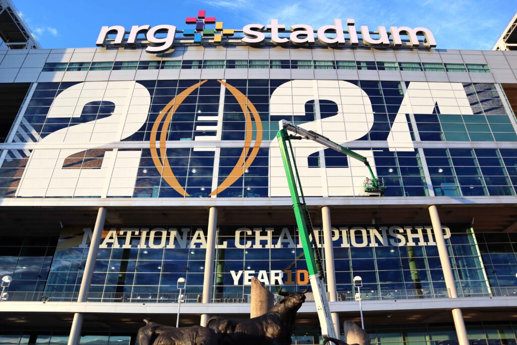 A3 Visual installation team applying window graphics at NRG Stadium for the 2024 College Football Playoff National Championship.