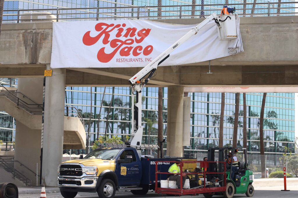 A3 Visual installation team applying racetrack tunnel graphics for King Taco at the 2026 Acura Grand Prix of Long Beach.