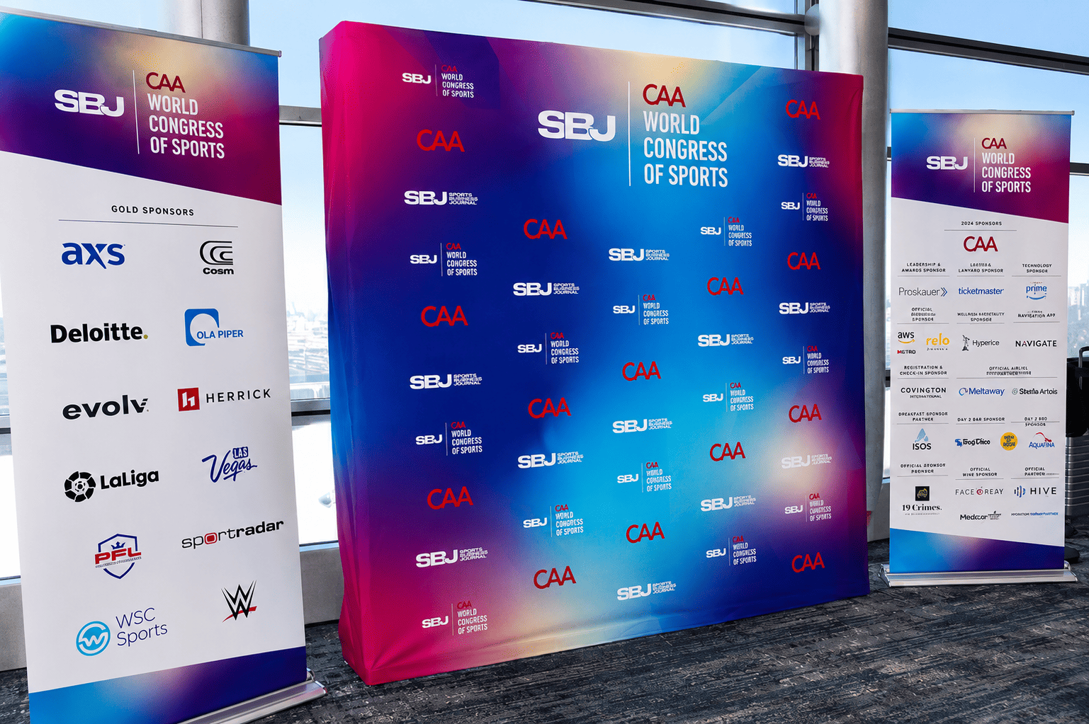 Large-format sponsor backdrop and event branding produced by A3 Visual for the Sports Business Journal World Congress of Sports.