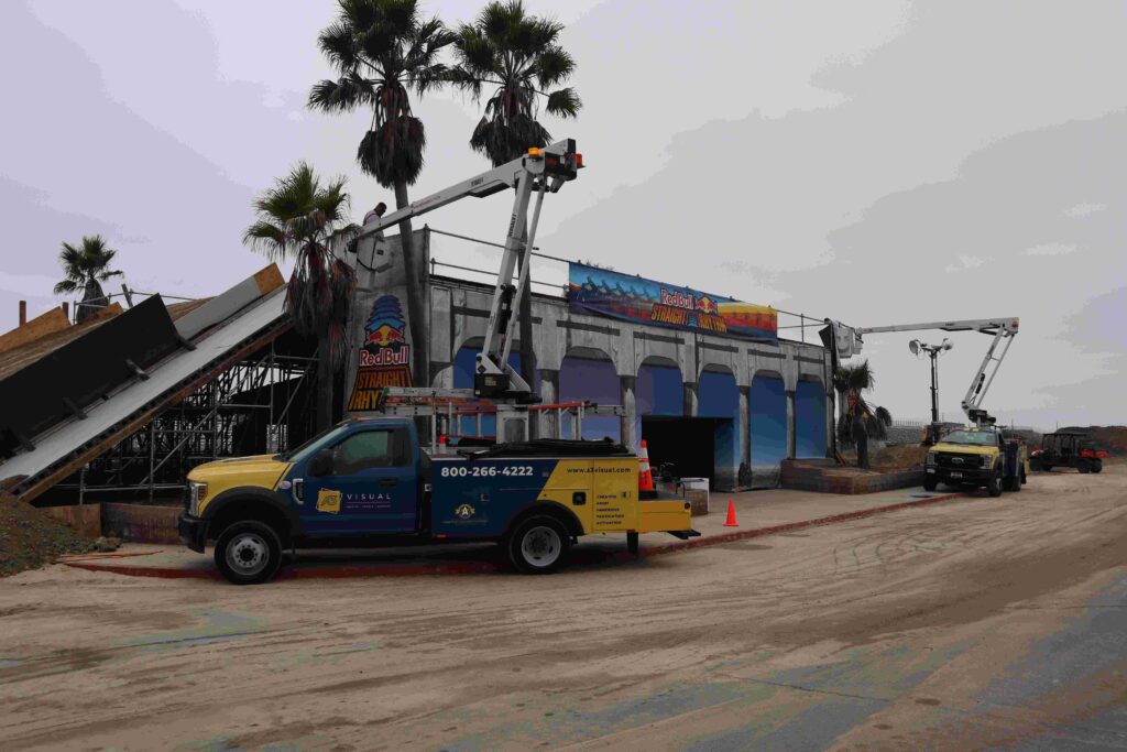 A3 Visual installation team installing large-format banners in hospitality areas for a Red Bull event.