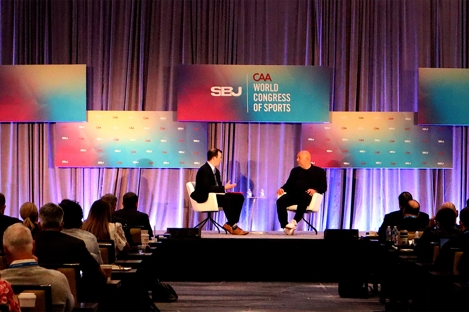 General session at the Sports Business Journal World Congress of Sports featuring keynote speakers on stage with custom event branding and large-format graphics produced by A3 Visual.