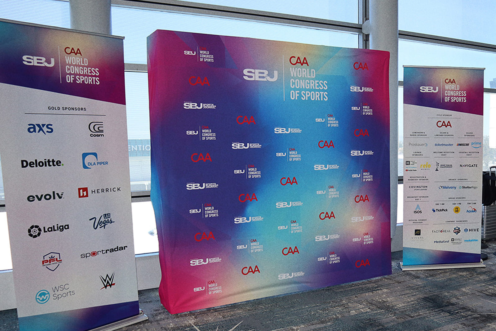 Large-format sponsor backdrop and event branding produced by A3 Visual for the Sports Business Journal World Congress of Sports.