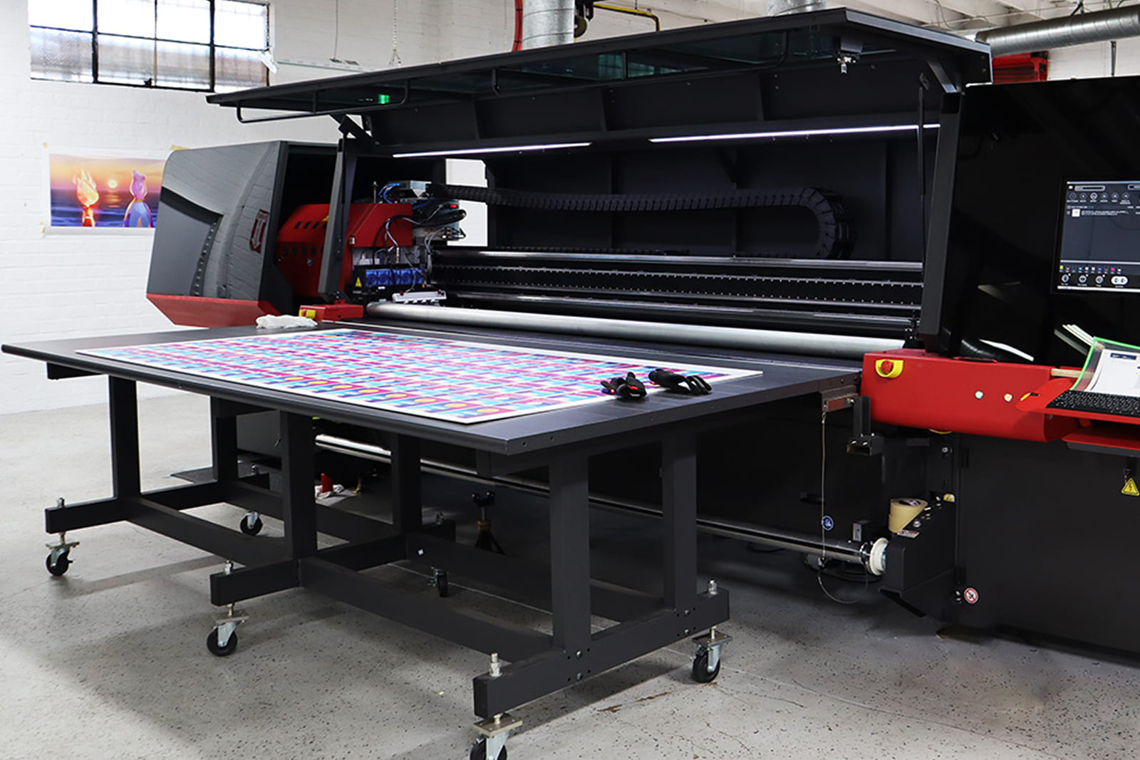 Large-format flatbed printer producing custom event graphics at A3 Visual's in-house production facility.